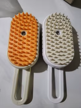Customer photo: orange and white Groomty brushes side by side